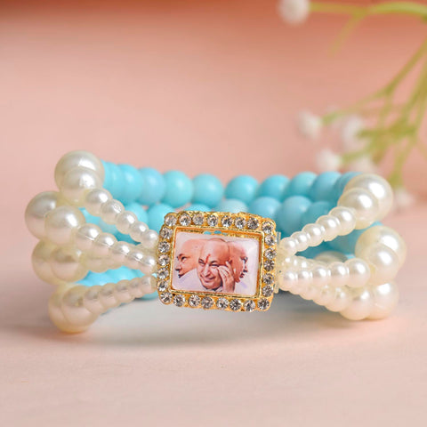Baby Blue & White Pearl Four Layer Guruji Swaroop Bracelet featuring soft baby blue beads and luminous white pearls with Jai Guruji Swaroop – perfect for spiritual wear, festive gifting, and daily devotion. India’s Largest Pooja Accessories Brand – www.satvikworld.com