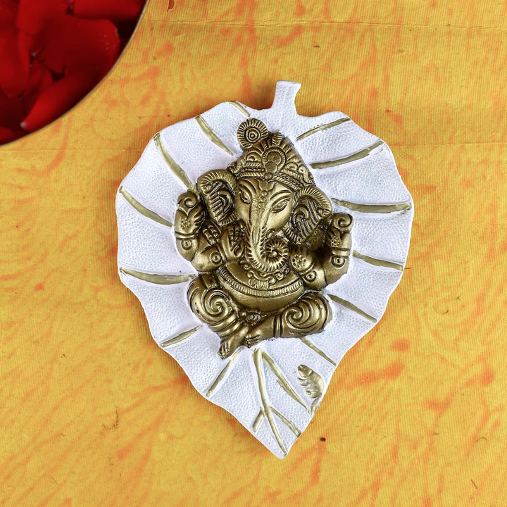 White Lord Ganesh on Leaf Patta Wall Hanging – Elegant and peaceful wall decor for pooja room or home. India’s Largest Pooja Accessories Brand – www.satvikworld.com