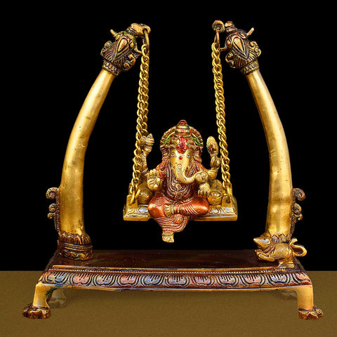 10.2-inch brass Ganpati idol seated on a decorative swing (jhula), beautifully crafted for devotion, home decor, and festive celebrations. India’s Largest Brass Idols Brand - www.satvikworld.com