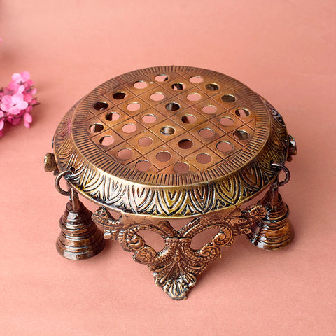 Bells of elegance: Artistic brass chowki, intricately designed with bell accents, perfect for placing deities or as a decorative centerpiece for spiritual spaces. Ideal for puja or home temple décor. India’s Largest Pooja Accessories Brand – www.satvikworld.com