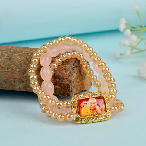 Golden Clear & Pink Triple Layer Guruji Swaroop Bracelet featuring sparkling golden clear beads with soft pink middle layer and Jai Guruji Swaroop – perfect for spiritual wear, meditation, and gifting. India’s Largest Pooja Accessories Brand – www.satvikworld.com