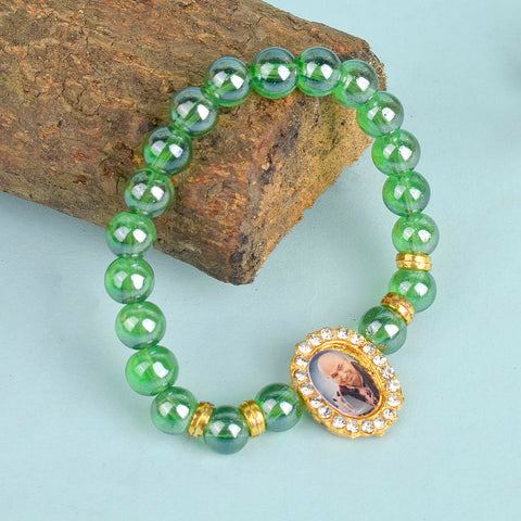 Green Shiny Beads Single Layer Guruji Swaroop Bracelet featuring dazzling green beads and Jai Guruji Swaroop – perfect for minimalist spiritual wear, meditation, and gifting. India’s Largest Pooja Accessories Brand – www.satvikworld.com