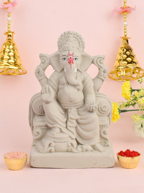 7 Inch Lord Ganesha idol seated majestically on a decorative Shinghasan, crafted in eco-friendly material with intricate detailing. India’s Largest Pooja Accessories Brand – www.satvikworld.com