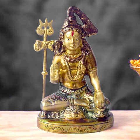 6-inch handcrafted brass Shiv idol, with Lord Shiva seated in a cross-legged posture and a trishul beside him. A finely crafted piece perfect for pooja rooms or spiritual spaces. India’s Largest Pooja Accessories Brand – www.satvikworld.com