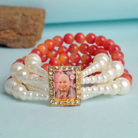 Red & White Pearl Four Layer Guruji Swaroop Bracelet featuring vibrant red beads and luminous white pearls with Jai Guruji Swaroop – perfect for spiritual wear, festive gifting, and daily devotion. India’s Largest Pooja Accessories Brand – www.satvikworld.com