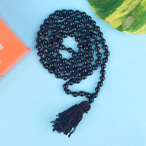 Authentic Shani Mala made with black beads for protection and positivity, designed for devotion to Shani Dev. Helps reduce Shani Dosha, attract stability, and bring spiritual growth. Ideal for meditation, Japa, and enhancing focus. India’s Largest Pooja Accessories Brand – www.satvikworld.com