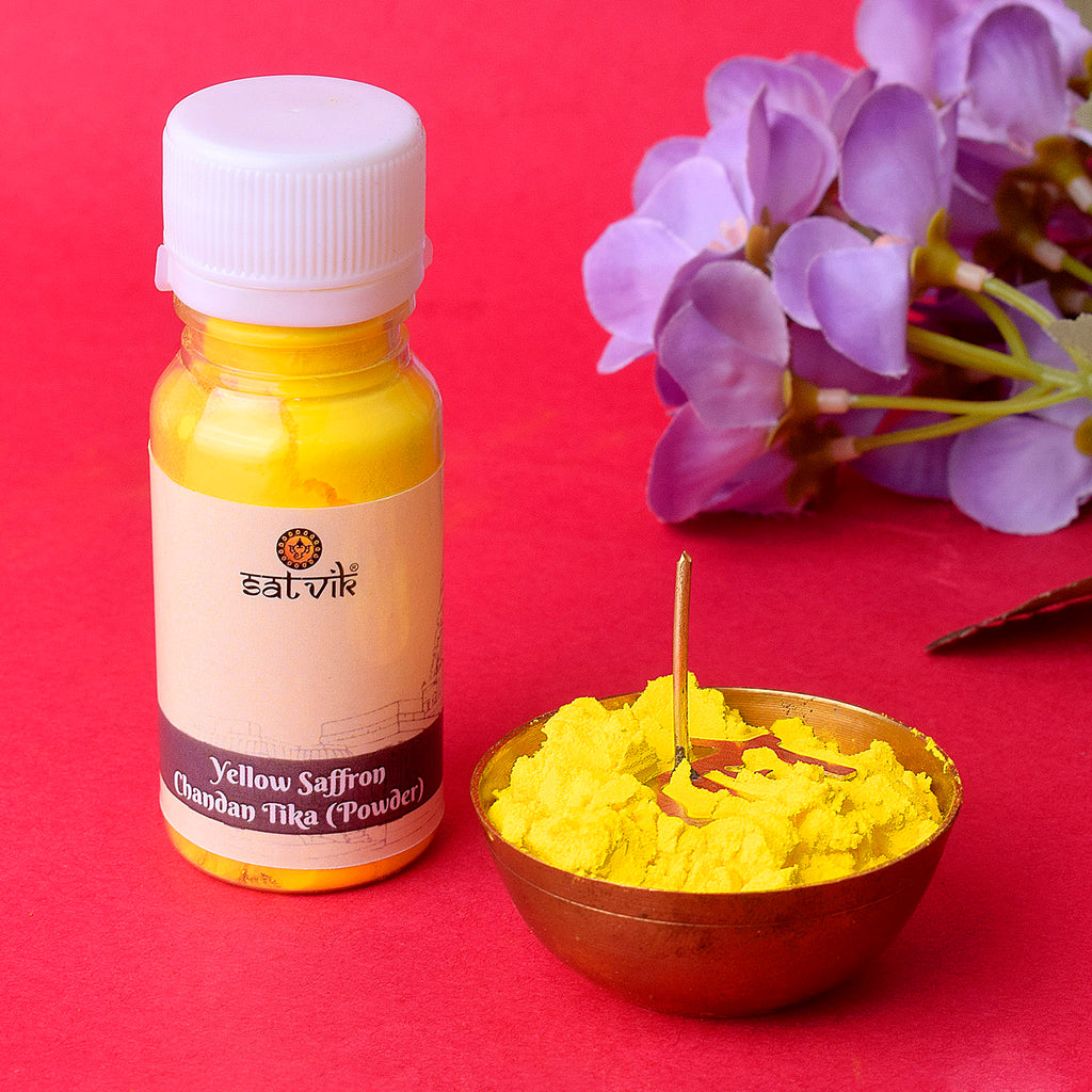 Yellow Saffron Chandan Tika Powder neatly placed in a traditional container, ideal for tilak application during pooja, spiritual rituals, and festive ceremonies. India’s Largest Pooja Accessories Brand – www.satvikworld.com