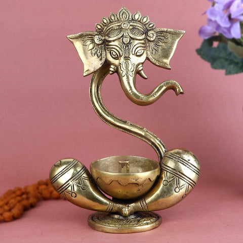 Alluring Brass Ganesh Akhand Diya, showcasing an intricately crafted Lord Ganesha figure with a traditional Akhand diya design, perfect for illuminating pooja rituals and bringing divine blessings into your home. India’s Largest Pooja Accessories Brand – www.satvikworld.com