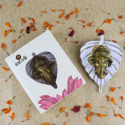 White-colored 1 Pc Lord Ganesh Face beautifully carved on a leaf patta wall hanging for home and spiritual décor. India’s Largest Pooja Accessories Brand – www.satvikworld.com